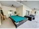 Entertainers patio featuring a pool table, ceiling fans, comfortable outdoor furniture, and room for activities at 143 Windsor Pl, Davenport, FL 33896