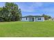 The property has a large backyard and a modern white home at 14470 Sw 46Th Ct, Ocala, FL 34473