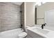This bathroom features modern tile work and updated sink and fixtures at 14470 Sw 46Th Ct, Ocala, FL 34473