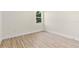 An airy bedroom features hardwood floors and a double hung window at 14470 Sw 46Th Ct, Ocala, FL 34473