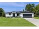 Charming single-story home with a well-maintained lawn and a two-car garage at 14470 Sw 46Th Ct, Ocala, FL 34473