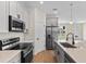 Modern kitchen with stainless steel appliances, quartz countertops, and ample cabinet space at 14470 Sw 46Th Ct, Ocala, FL 34473