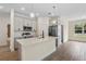 Stylish kitchen with a central island, stainless steel appliances, and modern pendant lighting at 14470 Sw 46Th Ct, Ocala, FL 34473
