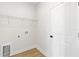 This laundry room features hardwood floors and a storage rack at 14470 Sw 46Th Ct, Ocala, FL 34473