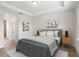 Cozy primary bedroom featuring a tray ceiling, soft lighting, and neutral color palette at 14470 Sw 46Th Ct, Ocala, FL 34473