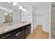 Bathroom features dual sinks, granite counters, a large mirror, and a glass-enclosed shower at 14518 Black Quill Dr, Winter Garden, FL 34787