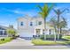 Charming two-story home with a well-manicured lawn and lovely palm trees at 14518 Black Quill Dr, Winter Garden, FL 34787