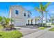 Stunning two-story home with a paved driveway and lush tropical landscaping at 14518 Black Quill Dr, Winter Garden, FL 34787