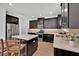 This gourmet kitchen features dark wood cabinetry, stainless steel appliances, and a spacious island at 14518 Black Quill Dr, Winter Garden, FL 34787