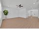 Spacious living room with hardwood floors, neutral paint, ceiling fan, and plenty of natural light at 14518 Black Quill Dr, Winter Garden, FL 34787