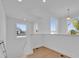 Bright stairwell with a large window and natural light highlighting the hardwood floors at 14518 Black Quill Dr, Winter Garden, FL 34787