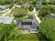 Aerial view of a home with a screened-in pool, solar panels, and lush landscaping in a residential area at 1525 Eagle Nest Cir, Winter Springs, FL 32708