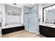 Bathroom featuring double sink vanity, tub, and glass shower at 1525 Eagle Nest Cir, Winter Springs, FL 32708