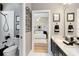 Nicely appointed bathroom featuring double sinks, granite counters, and decorative wrought iron details at 1525 Eagle Nest Cir, Winter Springs, FL 32708