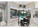 Bright dining room overlooking the pool with a modern chandelier and a comfortable seating arrangement at 1525 Eagle Nest Cir, Winter Springs, FL 32708