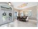 Elegant dining area featuring double-door entry, tiled flooring, and a decorative chandelier at 1525 Eagle Nest Cir, Winter Springs, FL 32708