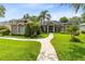 Charming single-story home showcasing a well-maintained lawn, mature landscaping, and a welcoming front entrance at 1525 Eagle Nest Cir, Winter Springs, FL 32708
