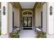 Inviting front entrance with double doors, decorative wreaths, and ample seating on the covered porch at 1525 Eagle Nest Cir, Winter Springs, FL 32708