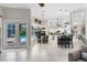 Bright, open kitchen with white cabinets, stainless appliances, breakfast bar, and access to outdoor pool area at 1525 Eagle Nest Cir, Winter Springs, FL 32708