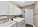 Well-organized laundry room with ample cabinet space and modern washer and dryer at 1525 Eagle Nest Cir, Winter Springs, FL 32708