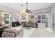 Cozy living room with stone fireplace, ceiling fan, neutral furnishings, and lots of natural light at 1525 Eagle Nest Cir, Winter Springs, FL 32708