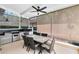 Covered outdoor dining area with ceiling fan and outdoor kitchen for all-season entertaining at 1525 Eagle Nest Cir, Winter Springs, FL 32708