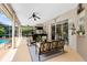 Covered outdoor patio with comfortable seating, a bar area, and views of the pool at 1525 Eagle Nest Cir, Winter Springs, FL 32708