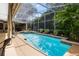 Inviting backyard oasis featuring a sparkling pool, spa, and lush tropical landscaping at 1525 Eagle Nest Cir, Winter Springs, FL 32708