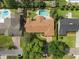 Home in aerial view featuring the roof, pool, driveway, landscaping, and surrounding neighborhood at 1618 Pepperidge Dr, Orlando, FL 32806