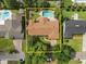 Aerial view of a home with a pool, patio, mature trees, and a lush green landscape at 1618 Pepperidge Dr, Orlando, FL 32806