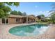 Beautiful backyard featuring a pool, covered patio, lush landscaping, and a well-manicured lawn at 1618 Pepperidge Dr, Orlando, FL 32806