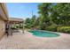 Backyard with a covered patio, an outdoor kitchen, and a refreshing swimming pool at 1618 Pepperidge Dr, Orlando, FL 32806