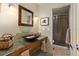 Stylish bathroom featuring a vessel sink, decorative mirror, and tiled walk-in shower at 1618 Pepperidge Dr, Orlando, FL 32806