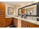 Granite countertop bathroom with double sink vanity and wood cabinets at 1618 Pepperidge Dr, Orlando, FL 32806