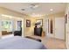 Bedroom featuring a bed, bench, and neutral carpet with attached sunroom at 1618 Pepperidge Dr, Orlando, FL 32806