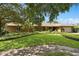 Exterior view of a home featuring beautiful landscaping, mature trees, and a large driveway at 1618 Pepperidge Dr, Orlando, FL 32806