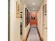 Inviting hallway featuring warm colors, recessed lighting, wood flooring, and decorative wall art at 1618 Pepperidge Dr, Orlando, FL 32806