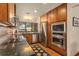 Modern kitchen featuring stainless steel appliances, granite countertops, and ample cabinet space at 1618 Pepperidge Dr, Orlando, FL 32806