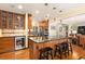 Contemporary kitchen with island seating, wine cooler, stainless steel appliances, and wooden cabinetry at 1618 Pepperidge Dr, Orlando, FL 32806