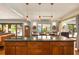 Open kitchen featuring a large island, pendant lighting, and dining area with natural light at 1618 Pepperidge Dr, Orlando, FL 32806