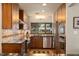 Modern kitchen with stainless steel appliances, dark countertops, and a view of the landscaped backyard at 1618 Pepperidge Dr, Orlando, FL 32806