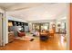 Expansive living area with hardwood floors, open layout, and seamless transition to the dining area and kitchen at 1618 Pepperidge Dr, Orlando, FL 32806