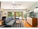 Cozy living room with modern sofa, wood floors, and access to outdoor area with pool view at 1618 Pepperidge Dr, Orlando, FL 32806