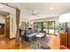 Stylish living room featuring modern furniture, access to the pool area, and bright natural light at 1618 Pepperidge Dr, Orlando, FL 32806