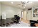 Home office includes L shaped desk, ceiling fan, and built in bookshelves at 1618 Pepperidge Dr, Orlando, FL 32806