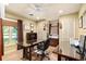 Home office includes a large desk, chair, with natural light and large window at 1618 Pepperidge Dr, Orlando, FL 32806
