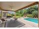 Covered patio featuring a ceiling fan, outdoor seating, and a view of the pool and backyard at 1618 Pepperidge Dr, Orlando, FL 32806