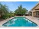 Inviting backyard pool with brick pavers and lush green landscaping, perfect for relaxing at 1618 Pepperidge Dr, Orlando, FL 32806