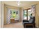 Sunroom adjacent to bedroom featuring a bench, large windows, and views of the pool at 1618 Pepperidge Dr, Orlando, FL 32806
