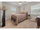 Neutral bedroom featuring a full-sized bed and two windows for natural light at 1620 Carolyn Ct, St Cloud, FL 34769